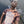 Load image into Gallery viewer, Model wearing the ROCKaBLOCK “All This Matters” tie-dye t-shirt featuring bold white text celebrating Black culture, standing in front of a chain-link fence.