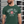 Load image into Gallery viewer, Man wearing a green t-shirt with &#39;Arsenal Tech&#39; design against a metallic background
