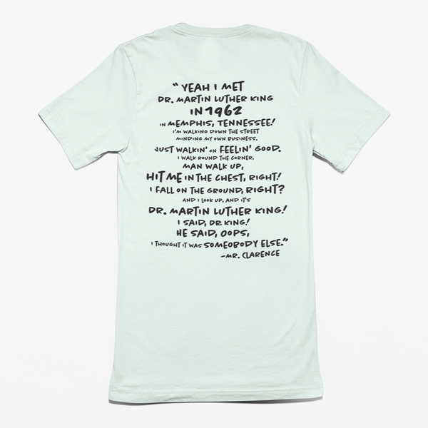 A ROCKaBLOCK "I Met Dr. King" graphic tee featuring marting Luther King Jr.  and  Cearance the barber from Coming to America with his quote on meeting Dr. King.