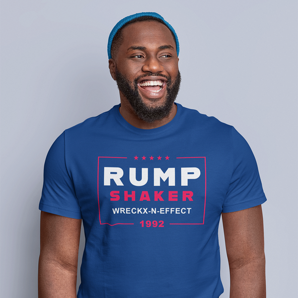 A man smiling and wearing a blue ROCKaBLOCK graphic tee with the text 'RUMP SHAKER WRECKX-N-EFFECT 1992' printed on the front.
