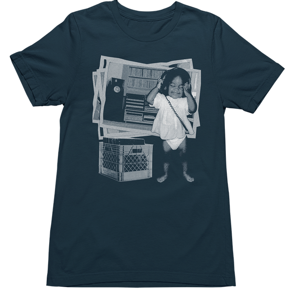 A dark navy blue short-sleeve t-shirt with a large graphic print on the front. The graphic is a black and white collage featuring a toddler in a white diaper wearing headphones, a speaker, and a milk crate.