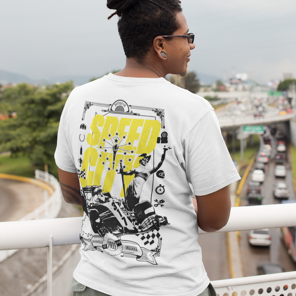 Person wearing a white t-shirt with graphic design, standing on a bridge overlooking a highway.